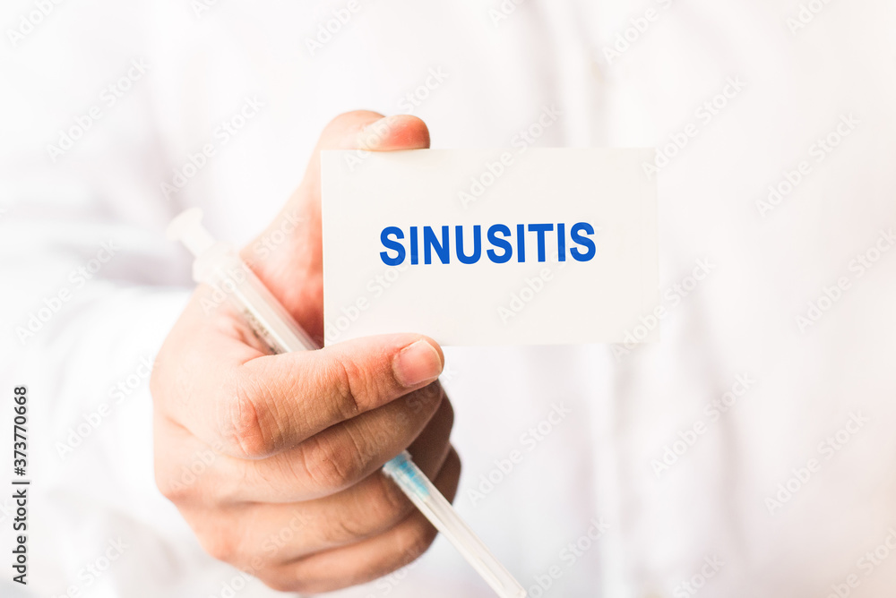 Word sinusitis on a white background with a syringe in hand. Medicine concept Word sinusitis on a white background with a syringe in hand. Medicine concept