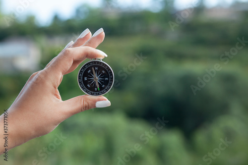 hand compass in nature background