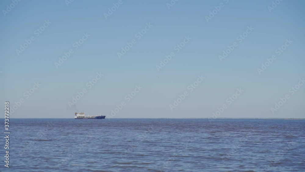 Large tankers and tugs go along the huge river. The ship is sailing along the Volga. Large tankers and tugs go along the huge river. The ship is sailing along the Volga.