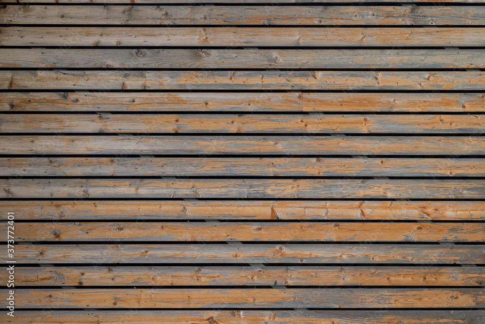 Fototapeta premium Texture of the wall covered with old wooden slats.