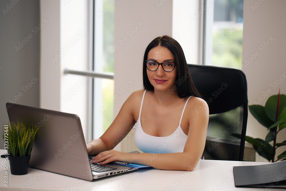 Focused woman working at her computer. Background for office startup Focused woman working at her computer. Background for office startup