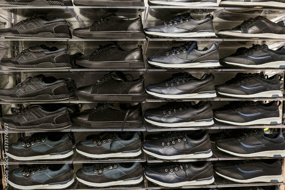 Multi-storey shelves with rows of man sport shoes