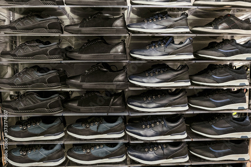 Multi-storey shelves with rows of man sport shoes