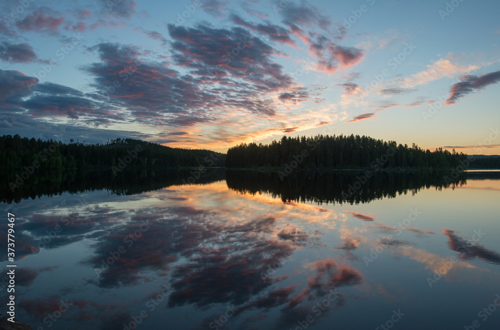 White nights over the calm nordic forest lake