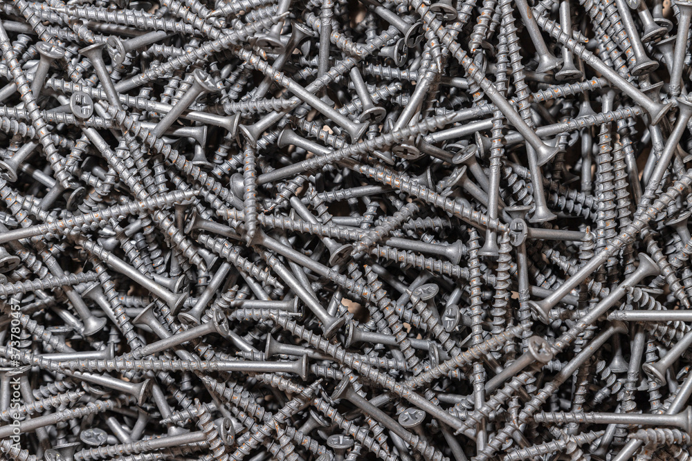 Wood screws. Texture. Background for wallpaper. A lot of long black screws. View from above. Wood screws. Texture. Background for wallpaper. A lot of long black screws. View from above.