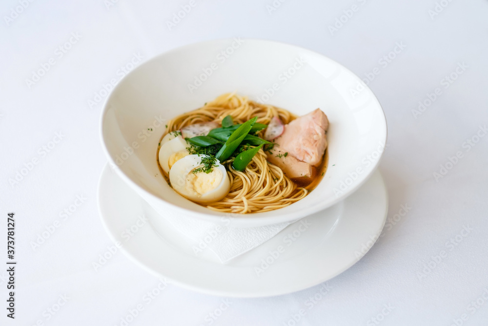 Ramen (Japanese soup with pork, egg noodles, egg, herbs and fish stock). Pretty homemade meal. Cooking and baking food while quarantining at home during the coronavirus pandemic. Ramen (Japanese soup with pork, egg noodles, egg, herbs and fish stock). Pretty homemade meal. Cooking and baking food while quarantining at home during the coronavirus pandemic.