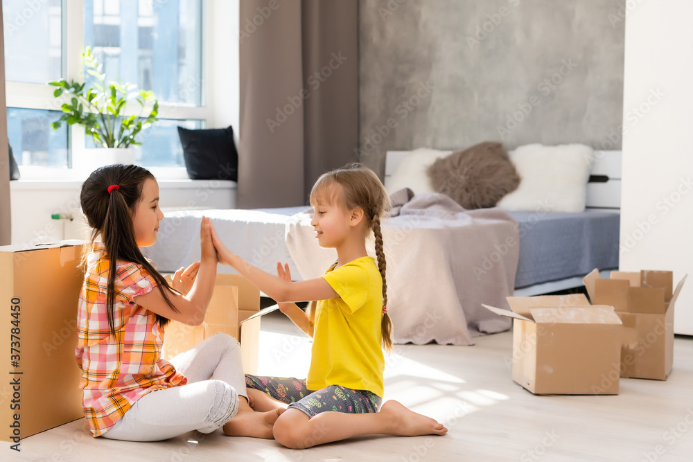 Excited funny kids girls running inside luxury big modern house on moving day, cute children entering exploring new home, happy young family buying real estate Excited funny kids girls running inside luxury big modern house on moving day, cute children entering exploring new home, happy young family buying real estate