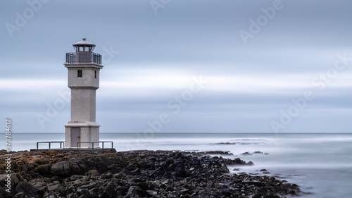 lighthouse on the coast of the sea photo