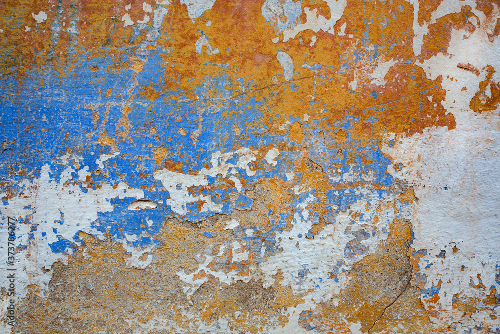 Texture of old wall with shabby orange and blue paint. Background Texture of old wall with shabby orange and blue paint. Background