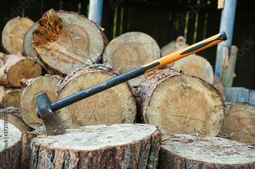 axe on a background of wooden firewood