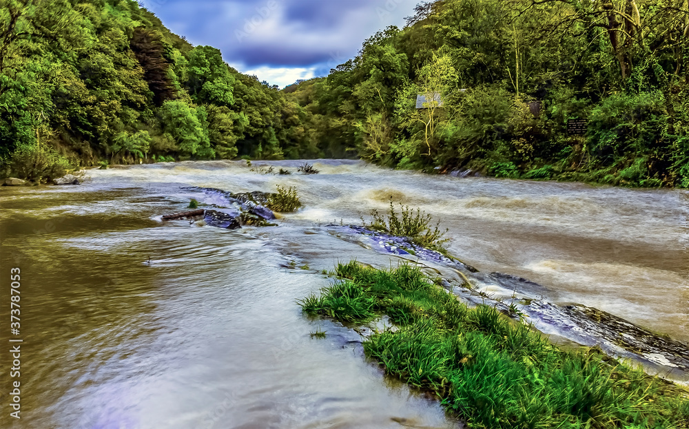 A long exposure view from Cenarth up the river Teifi, Wales after heavy rainfall A long exposure view from Cenarth up the river Teifi, Wales after heavy rainfall