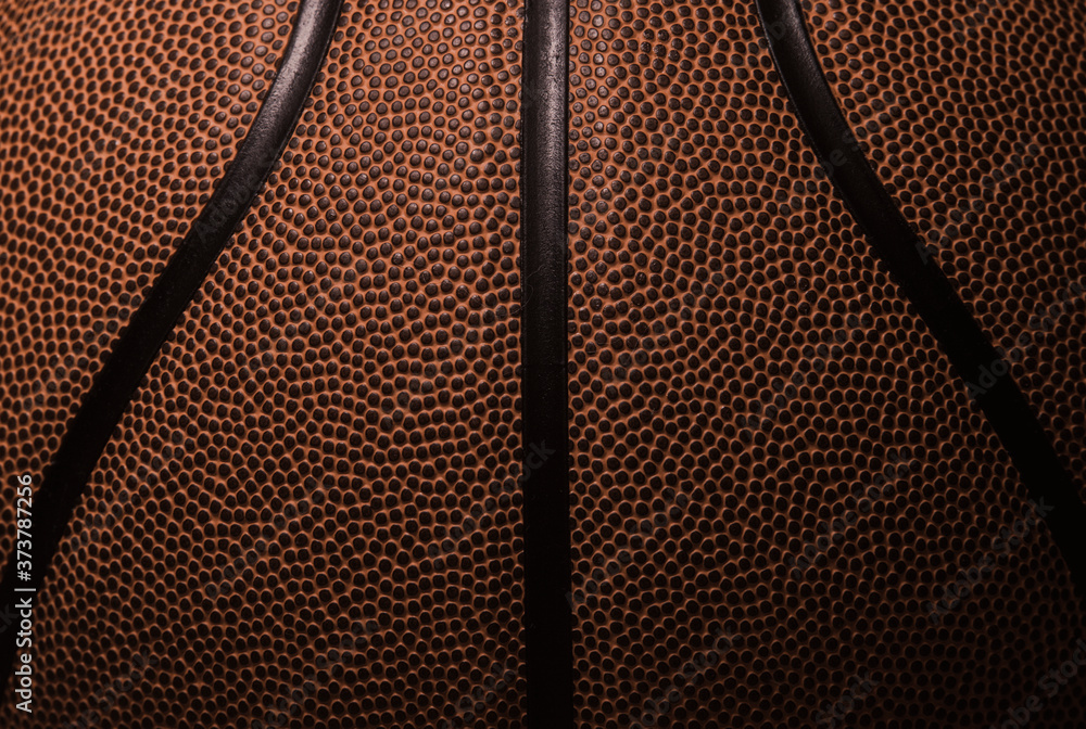 Fototapeta premium Closeup detail of basketball ball texture background. Team sport concept.