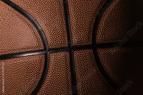 Closeup detail of basketball ball texture background. Team sport concept. © Augustas Cetkauskas