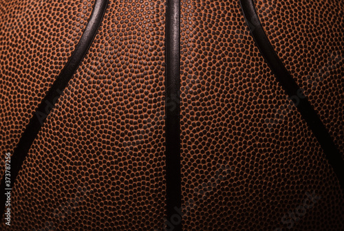 Closeup detail of basketball ball texture background. Team sport concept. © Augustas Cetkauskas