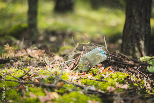 Plastic bottle rubbish left in the forest or park 