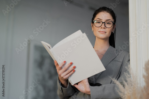 young woman reading a newspaper
