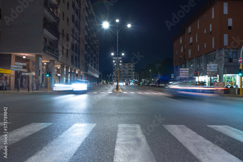 Timelapse view of traffic at an urban night intersection. Urban movement in the Italian city in the evening.