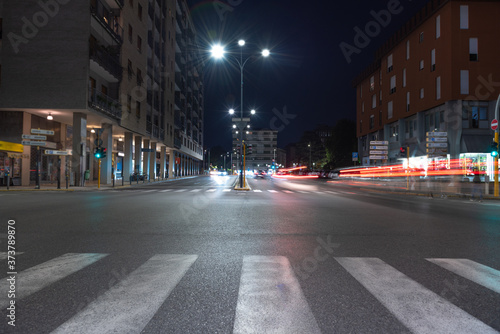 Timelapse view of traffic at an urban night intersection. Urban movement in the Italian city in the evening.