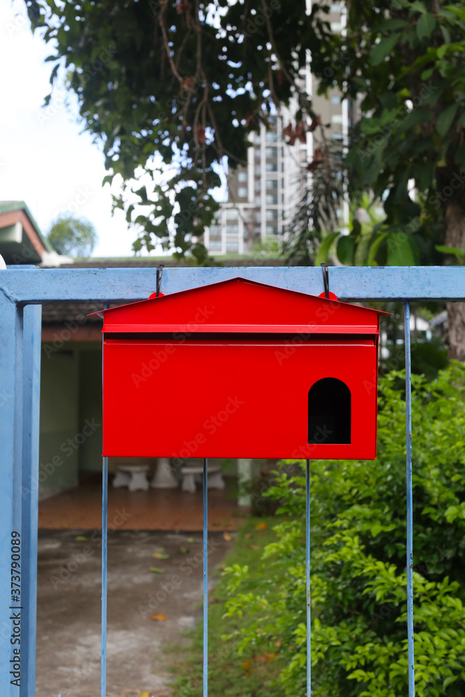 Red mailbox Hanging on the home fence. Red mailbox Hanging on the home fence.