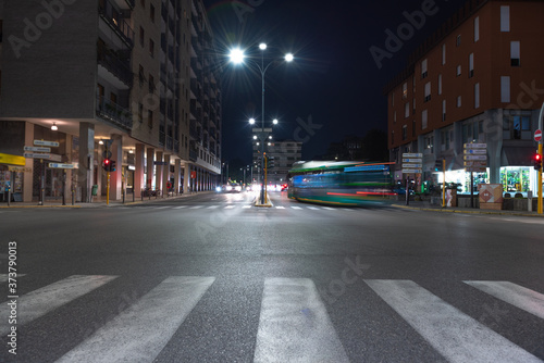Timelapse view of traffic at an urban night intersection. Urban movement in the Italian city in the evening. © OlgaLitvinovaFoto