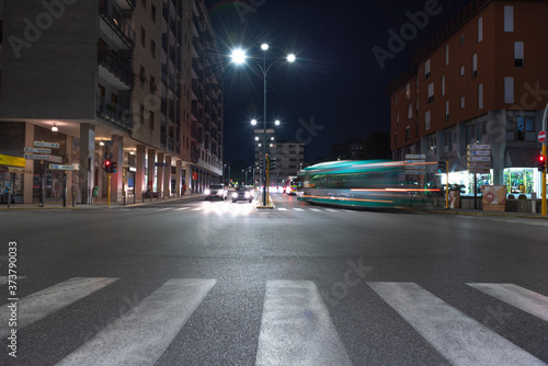 Timelapse view of traffic at an urban night intersection. Urban movement in the Italian city in the evening. © OlgaLitvinovaFoto