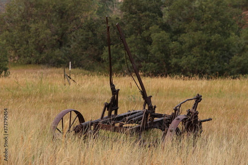 Fotografie Abandoned antique old farm equipment