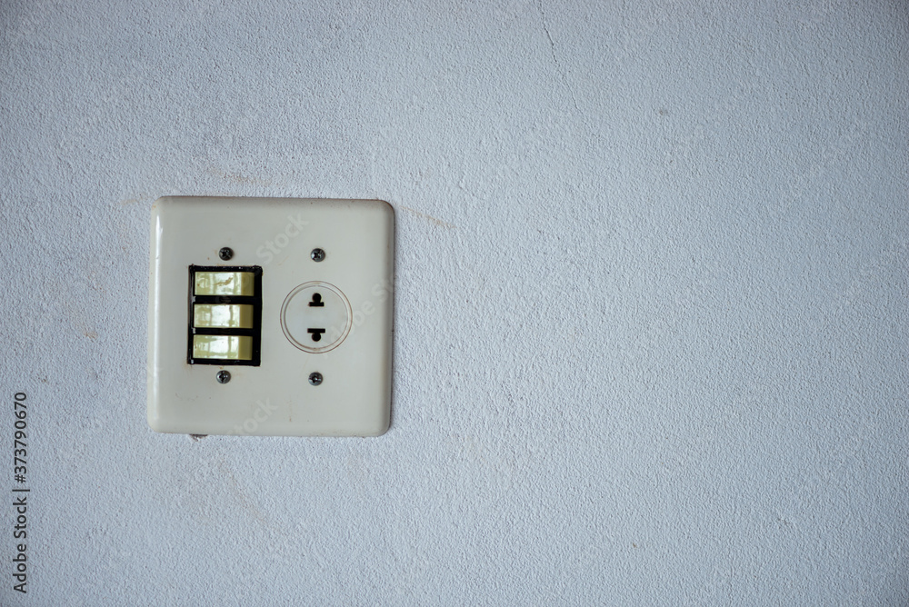 Old not branded dirty light switch and wall plug Old not branded dirty light switch and wall plug
