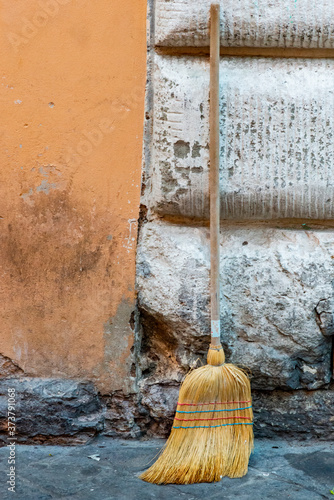Italy, Rome. Via Ripetta, broom on sidewalk. photo