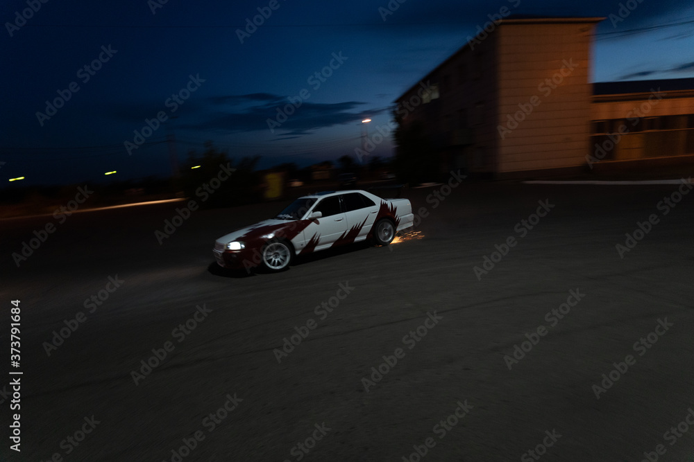 Russia, Buryatia, Ulan Ude, July, 2020: a racing car, decorated and tuned, drifting in the night Russia, Buryatia, Ulan Ude, July, 2020: a racing car, decorated and tuned, drifting in the night