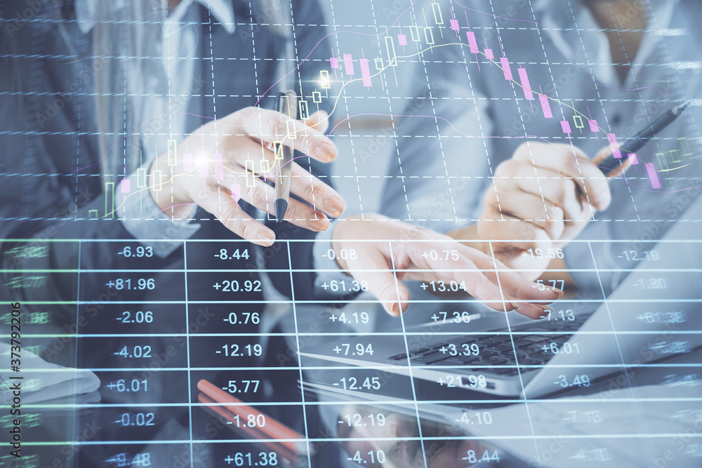 Multi exposure of man and woman working together and financial chart hologram. Business concept. Computer background. Multi exposure of man and woman working together and financial chart hologram. Business concept. Computer background.