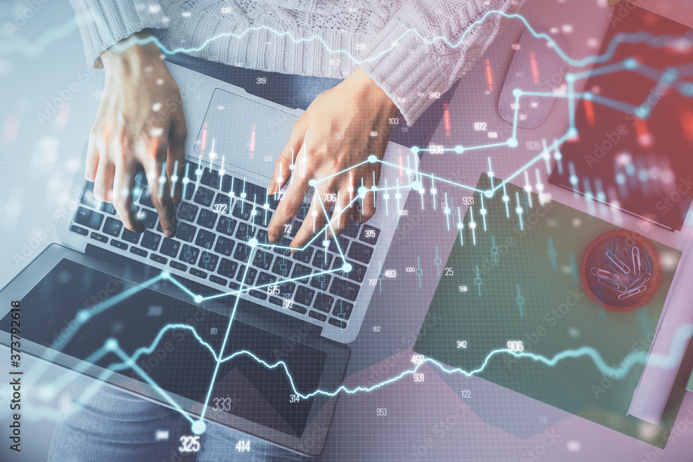 Multi exposure of woman hands working on computer and forex chart hologram drawing. Top View. Financial analysis concept. Multi exposure of woman hands working on computer and forex chart hologram drawing. Top View. Financial analysis concept.