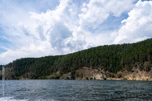 Russia  Irkutsk region  Baikal lake  July 2020  yellow cliff with forest on the top  from water view