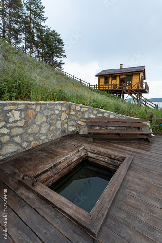 Russia, Irkutsk region, Baikal lake, July 2020: rural square bathhouse with hot water