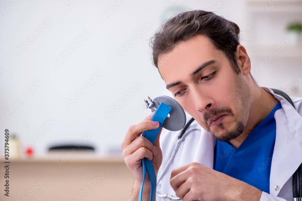 Young male doctor working in the clinic Young male doctor working in the clinic