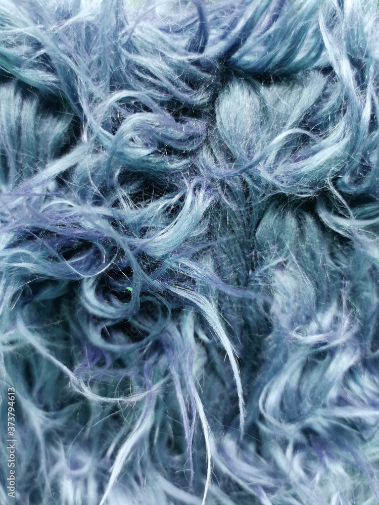 Close up of a blue dyed sheepskin rug as a background Close up of a blue dyed sheepskin rug as a background