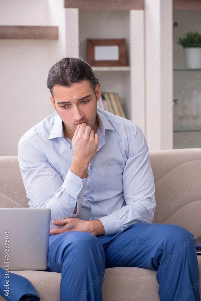 Young male employee working from the house Young male employee working from the house