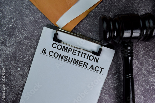 Competition & Consumer Act text write on a paperwork and gavel isolated on office desk.