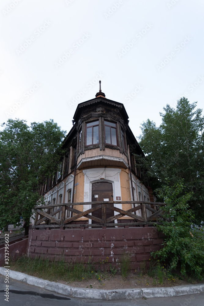 Russia, Buryatia, Ulan Ude, July, 2020: old wooden house in a city centre on a summer evening Russia, Buryatia, Ulan Ude, July, 2020: old wooden house in a city centre on a summer evening