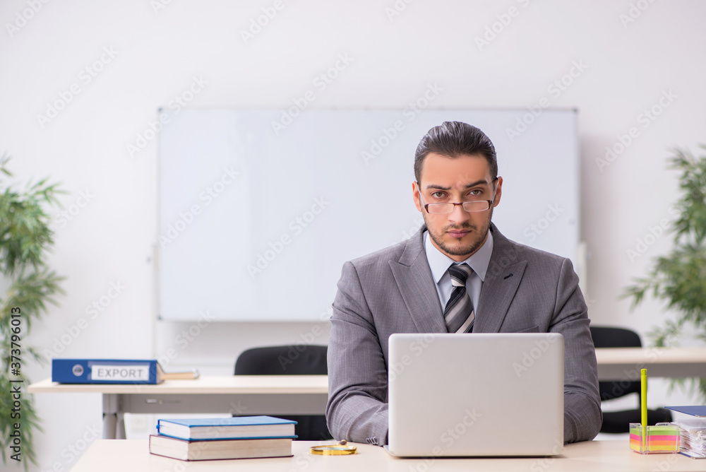 Young male employee working in the office Young male employee working in the office
