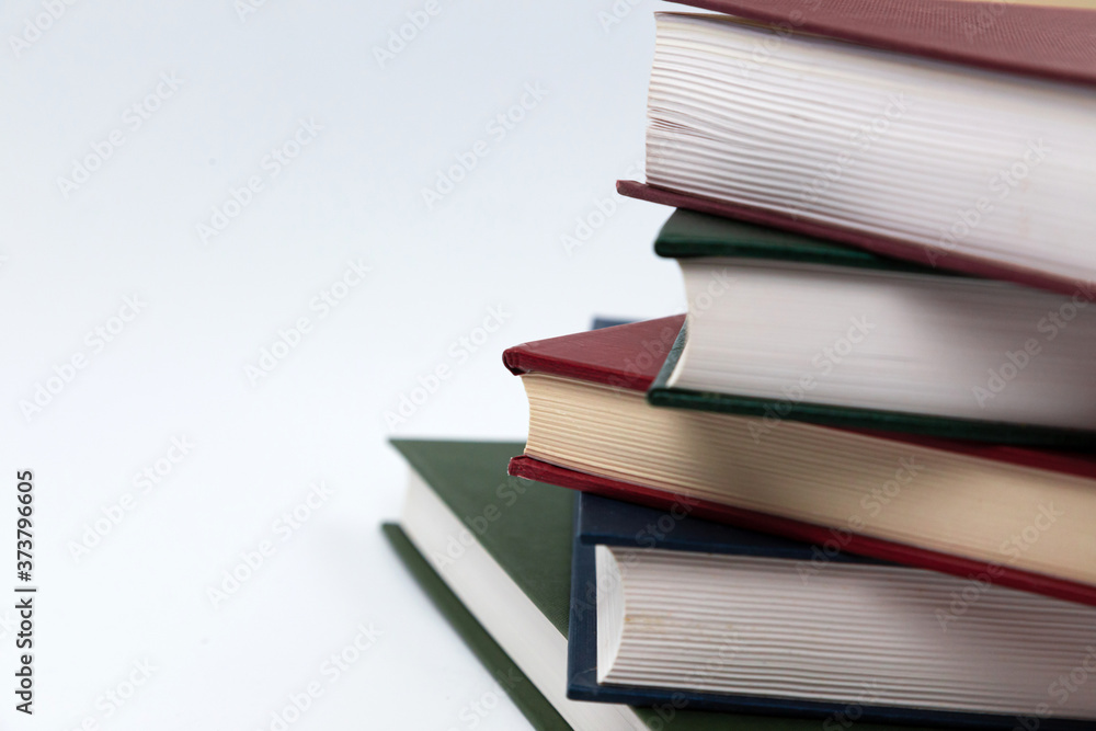 Book stack on a white background. Education concept side view close up Book stack on a white background. Education concept side view close up