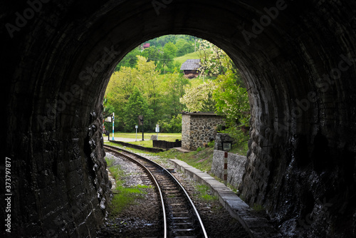Narrow-gauge heritage railway track for the Sargan Eight train running through a tunnel, Mokra Gora, Serbia photo