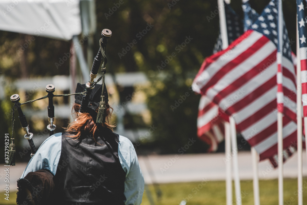 Bagpipe memorial service with flags Stock Photo | Adobe Stock