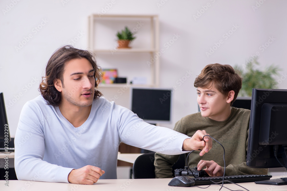 Father and son playing computer games Father and son playing computer games