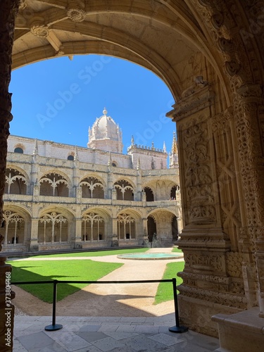 Inside the beautiful Hieronymites Monastery of Jeronimos with the beautiful green garden in Belem, Lisbon, Portugal
