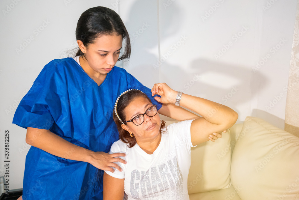 Fototapeta premium Physical therapist exercising with female rheumatism patient