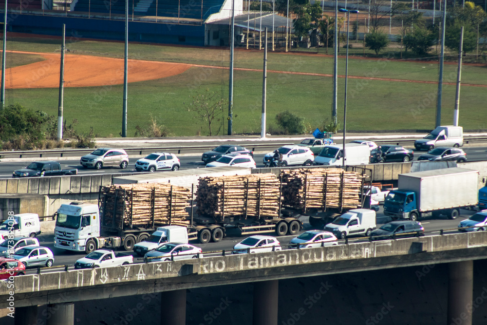 Vehicles traffic and wooden truck on Marginal do Tiete River Avenue in the north side of Sao Paulo city.