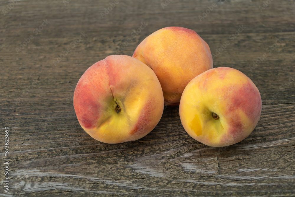 Juicy and delicious peaches on a wooden background Juicy and delicious peaches on a wooden background