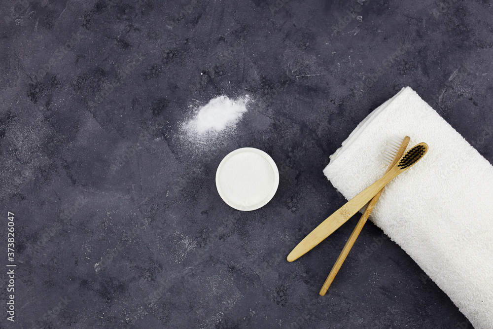 Bamboo toothbrushes, a white cotton towel and powder for brushing your teeth in bowl . No plastic, zero waste concept. Bamboo toothbrushes, a white cotton towel and powder for brushing your teeth in bowl . No plastic, zero waste concept.