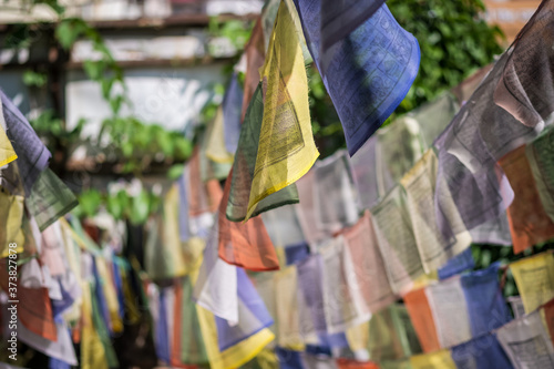 Background image of Tibetan prayer flags in an urban setting