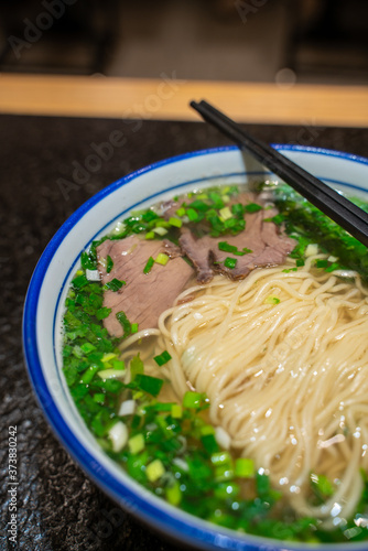 A bowl of traditional Chinese Lanzhou beef noodle soup.